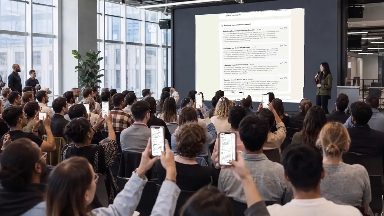 Play the IdeaJar video: a hall watching session patterns on the big screen, phones raised